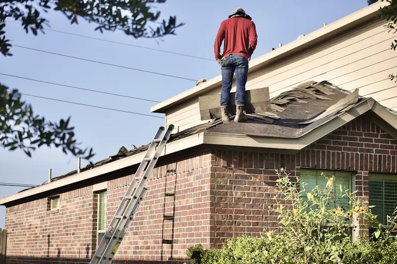 Professional roofer working on a residential roof in Clemsonville